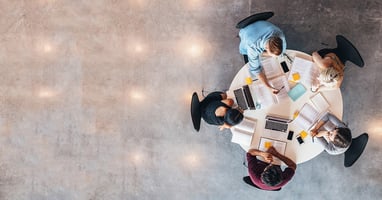 People working together sitting around a table