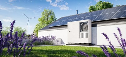 A heat pump placed on the outside of a home in the daylight