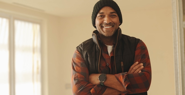 Man smiling in beanie hat and jacket